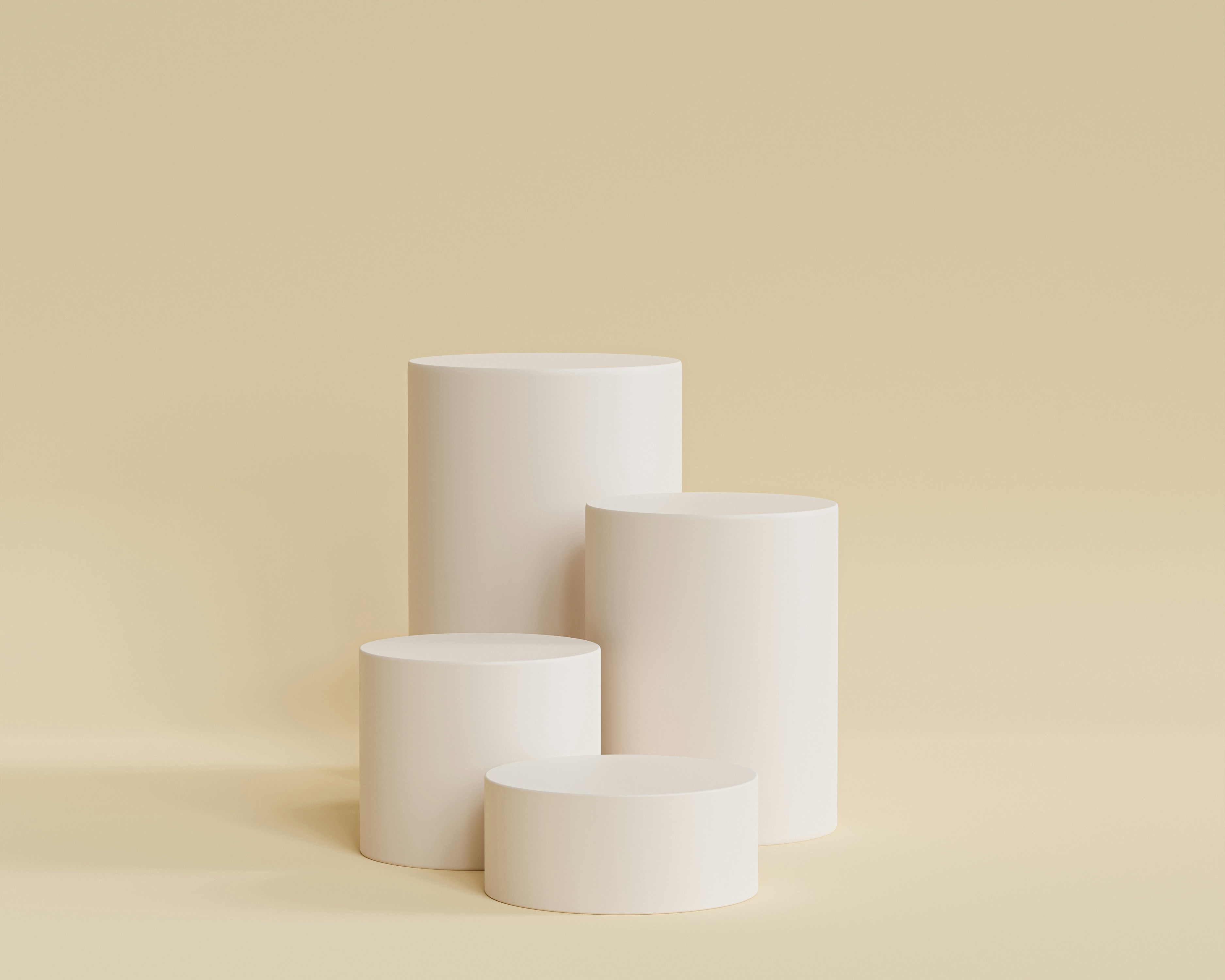 A render of three white cylindrical columns, against a warm creme background
